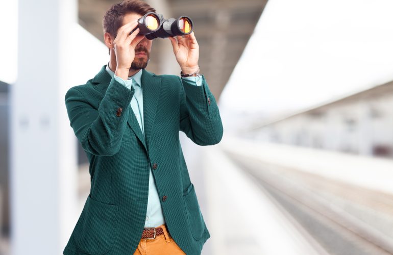 Businessman looking for with binoculars